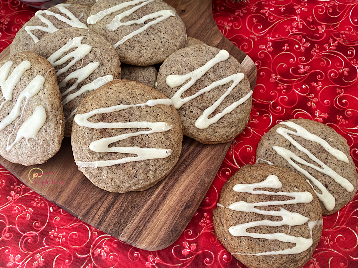 chai cookies with eggnog frosting on wooden board with red background