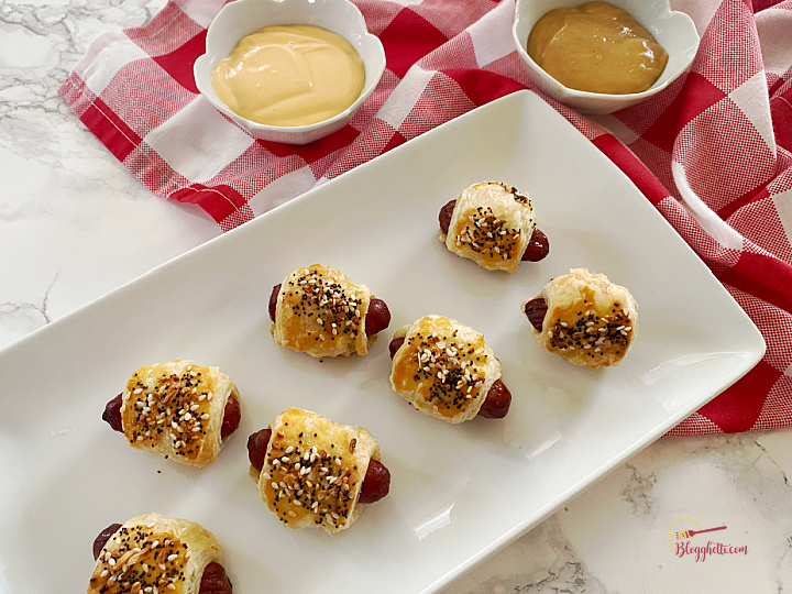 overhead shot of mini pigs in blanket with sauces on the side