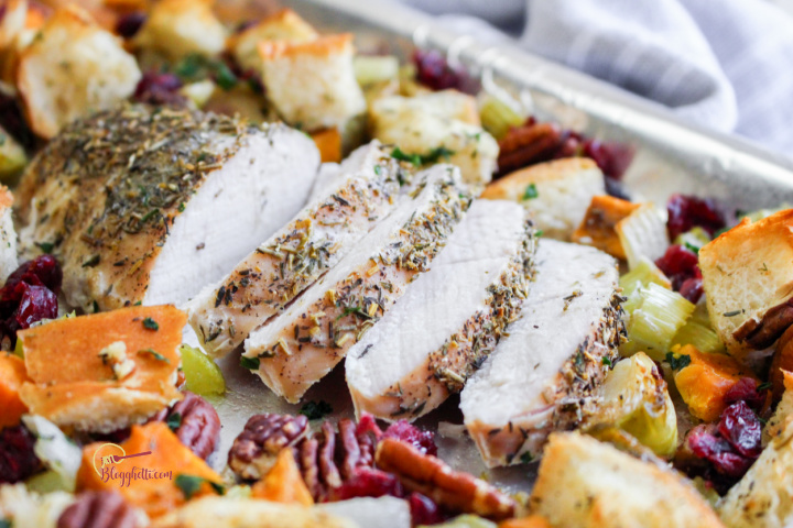 sliced turkey roasted with vegetables on sheet pan