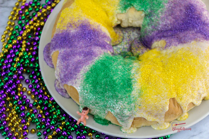 Easy king cake with colored sugar on white serving plate