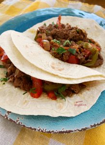 Slow Cooker Shredded Beef Fajitas on blue plate