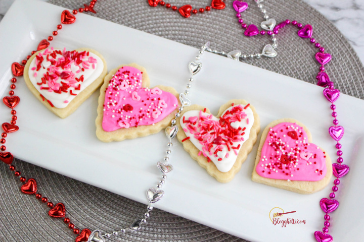 Valentines Day Sugar Cookies on white tray with decorative beads