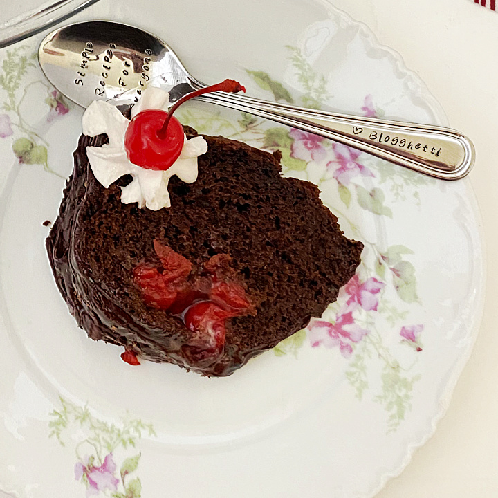 black forest cake slice on plate with spoon