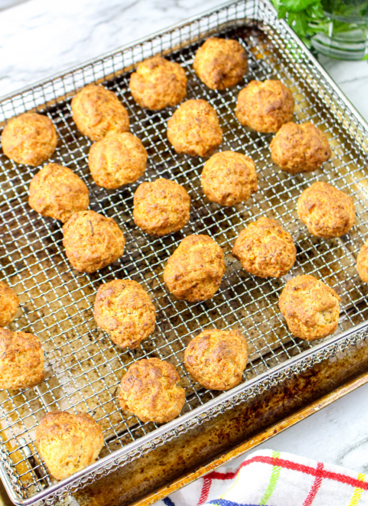 cheesy sausage balls cooling on wire rack