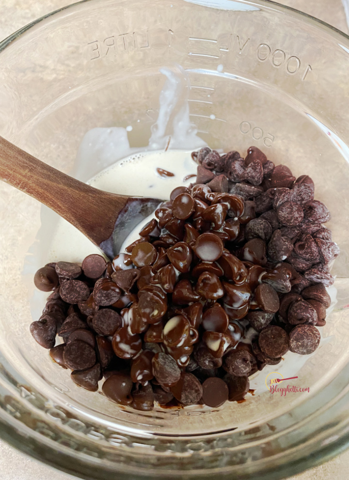 melting chocolate chips with cream in glass bowl
