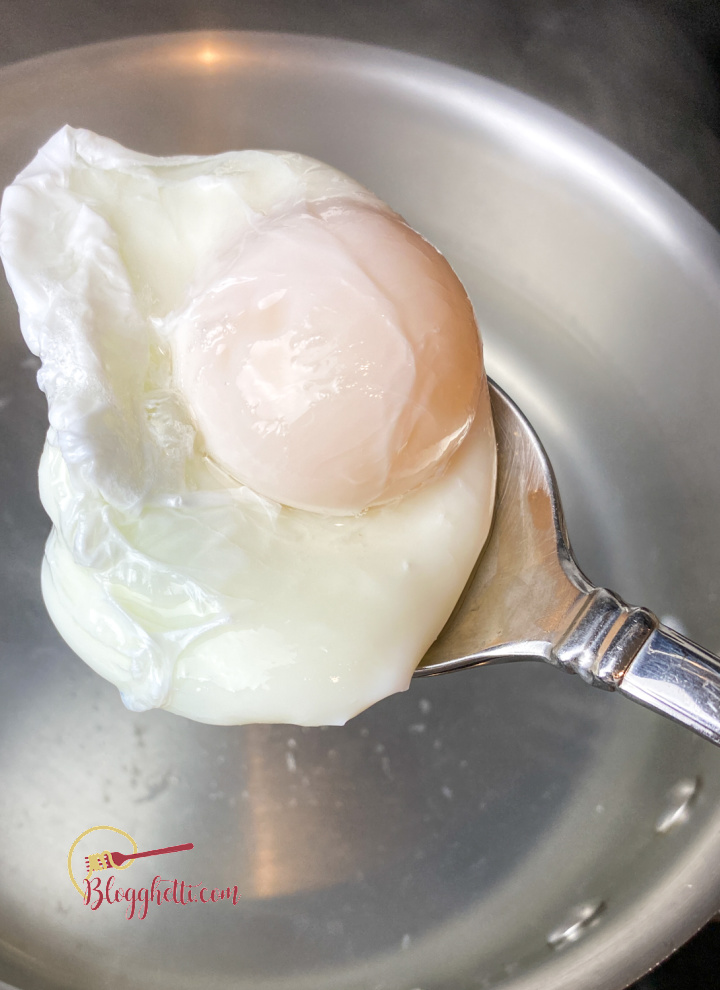 A poached egg fresh out of boiling water
