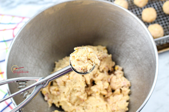 scooping sausage mixture into balls to cook in air fryer