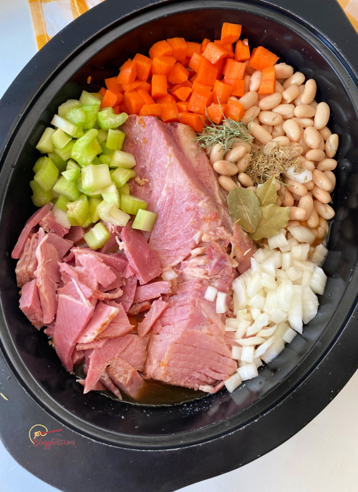 slow cooker filled with ham soup ingredients