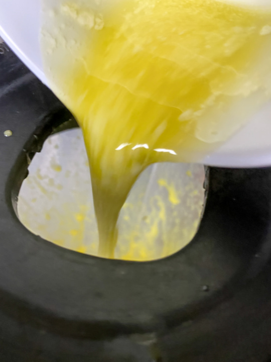 slowly adding melted butter to blender