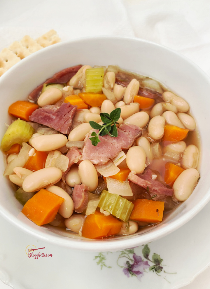 white bowl filled with ham and white bean soup