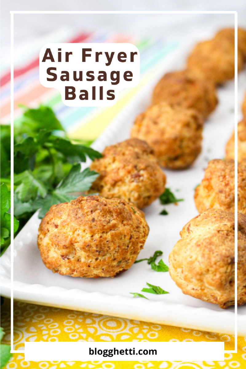 Crispy air fryer sausage balls on a white plate, garnished with fresh parsley.