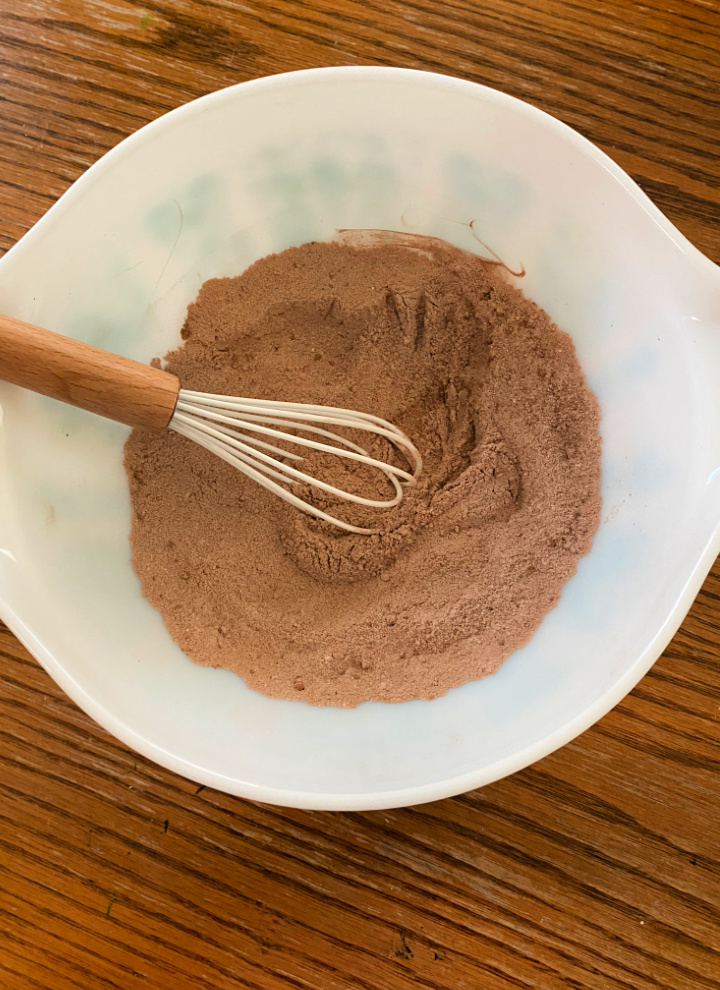 cake mix in white bowl with whisk