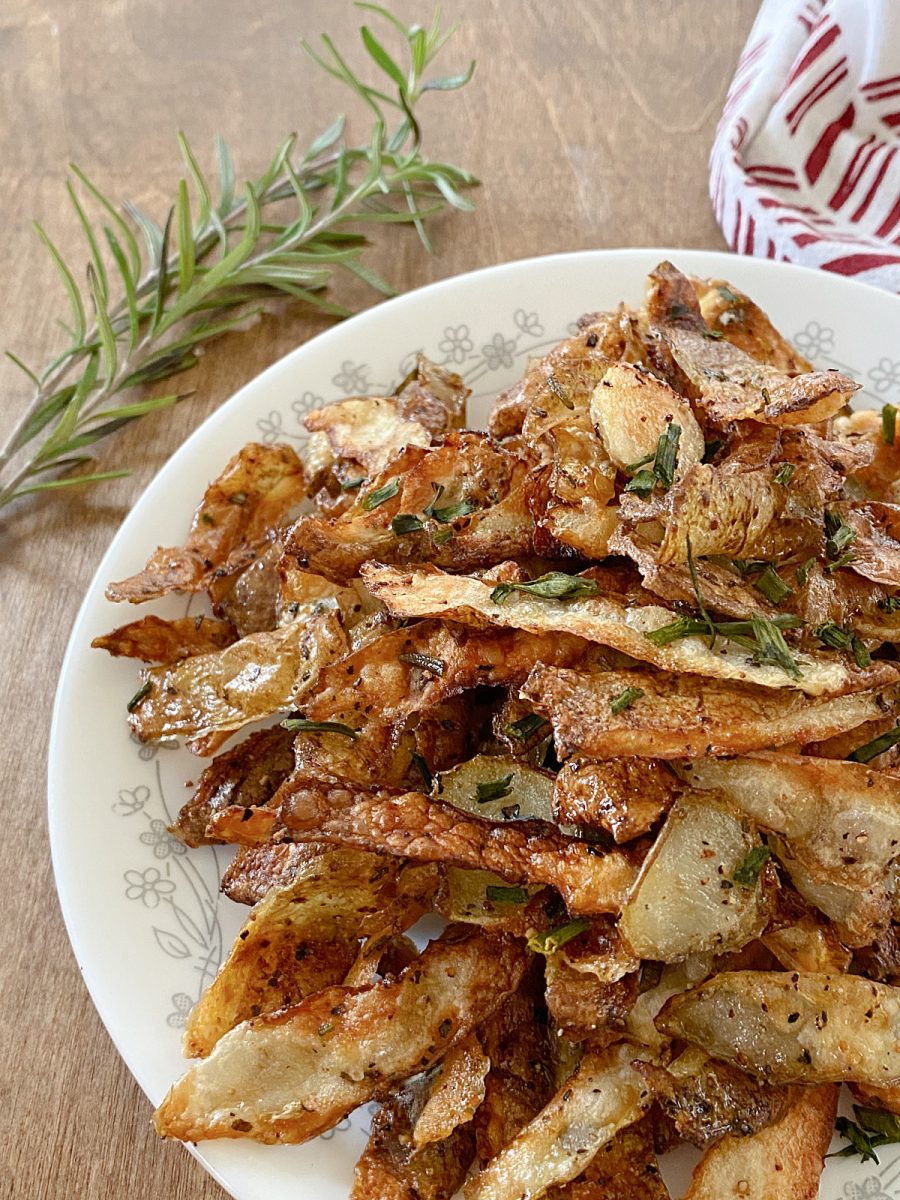 close up of baked potato peels with herbs