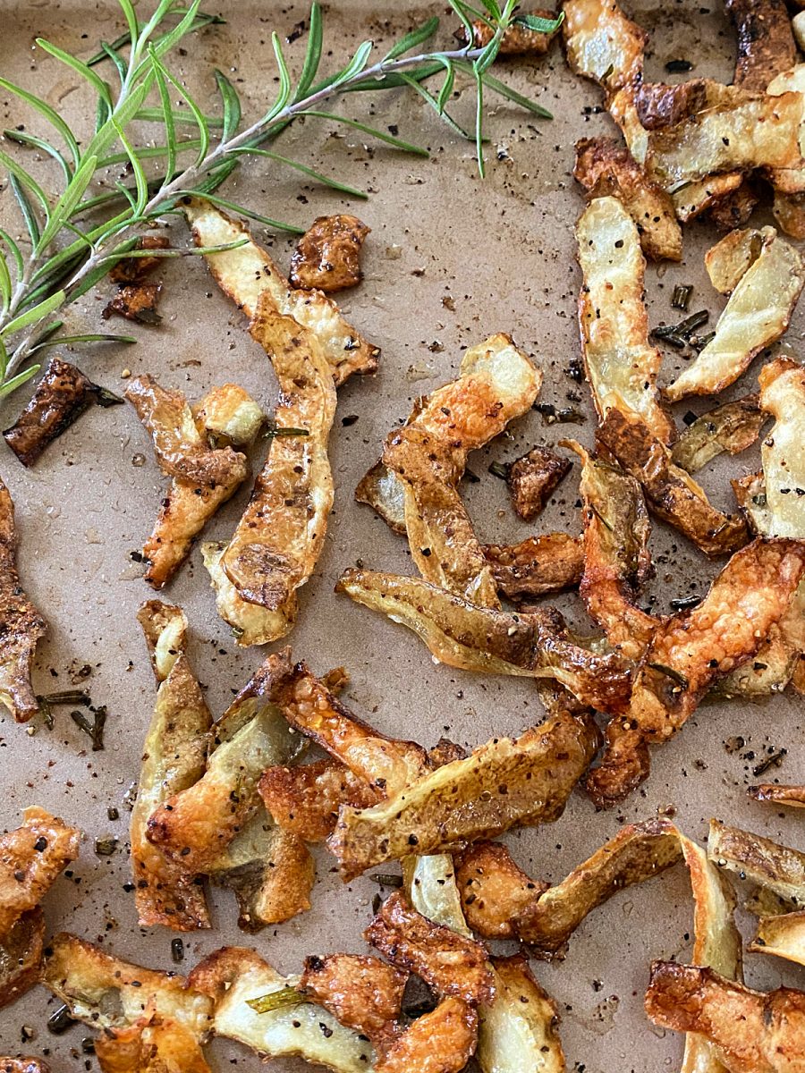 close up of roasted skins with rosemary sprig