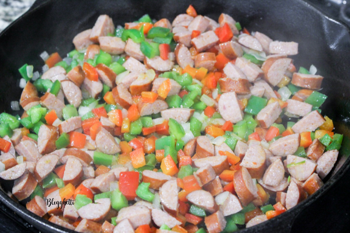 sauting vegetables and sausage in skillet