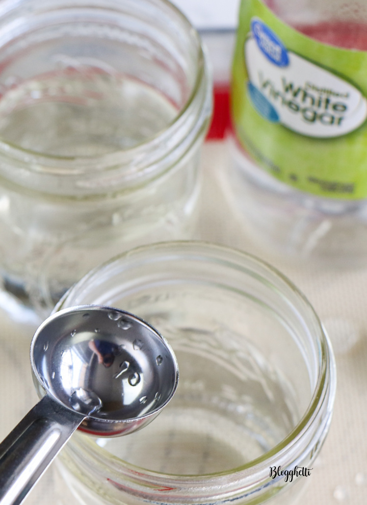 boiling water and vinegar in mason jars for dying eggs