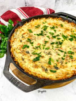 cast iron skillet with a potato crusted frittata