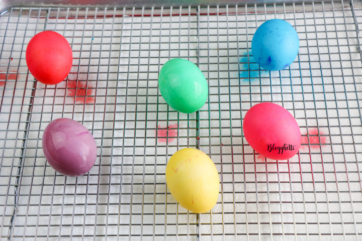 dyed Easter eggs drying on wire rack