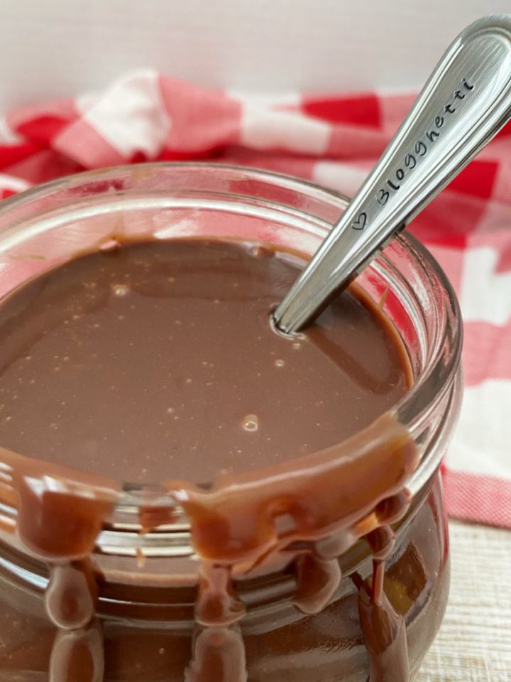 hot fudge syrup in a jar with a spoon