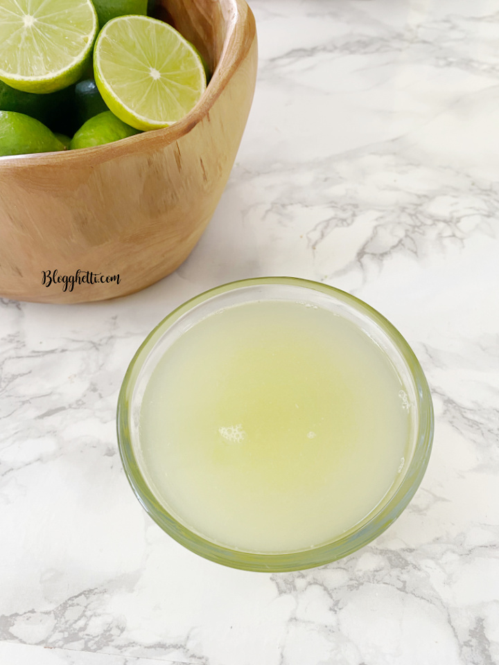 key lime juice in bowl with limes in background