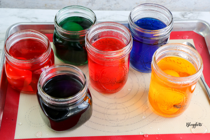 mason jars with colored dye and eggs