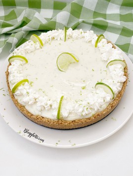 overhead view of key lime pie with oat graham crust on white plate