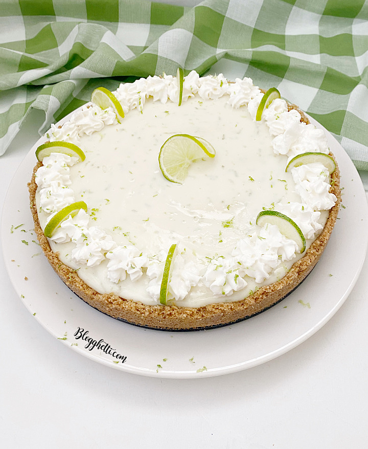 overhead view of key lime pie with oat graham crust on white plate