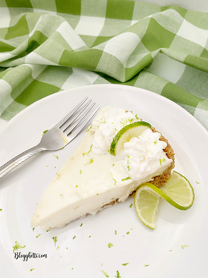 slice of lime pie on white plate with green checkered napkin in background