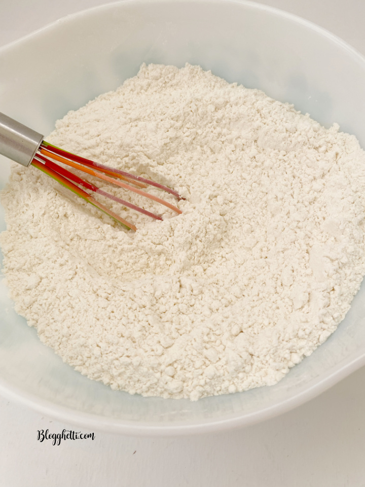 whisk and bowl with dry ingredients