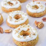carrot cake donuts with icing and pecans
