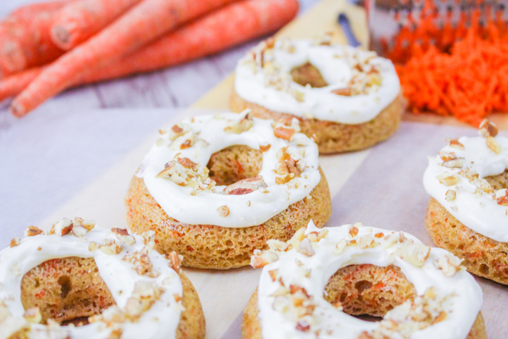 close up of baked carrot cake donuts with pecans