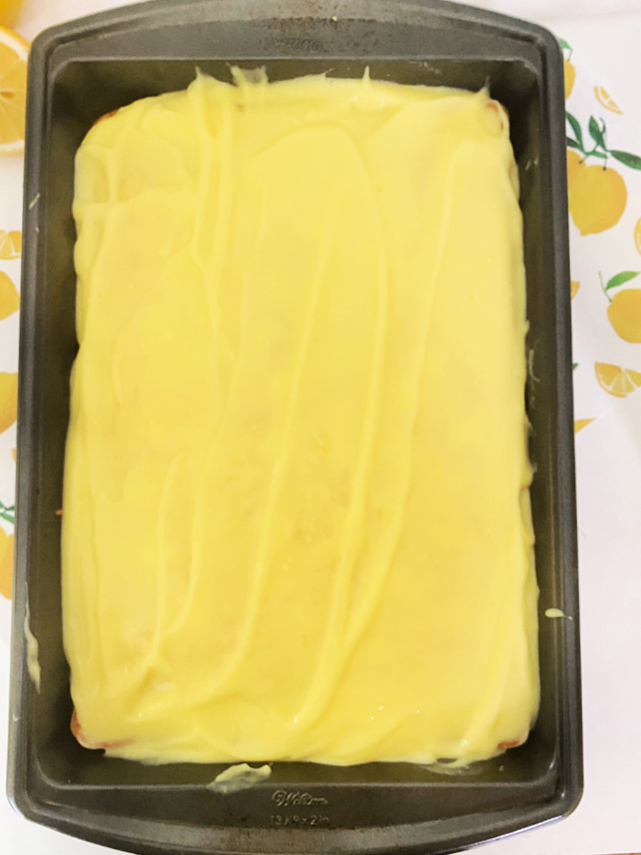 adding the lemon pudding to cake