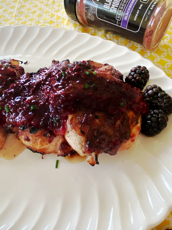 blackberry glazed chicken on platter with seasoning in background