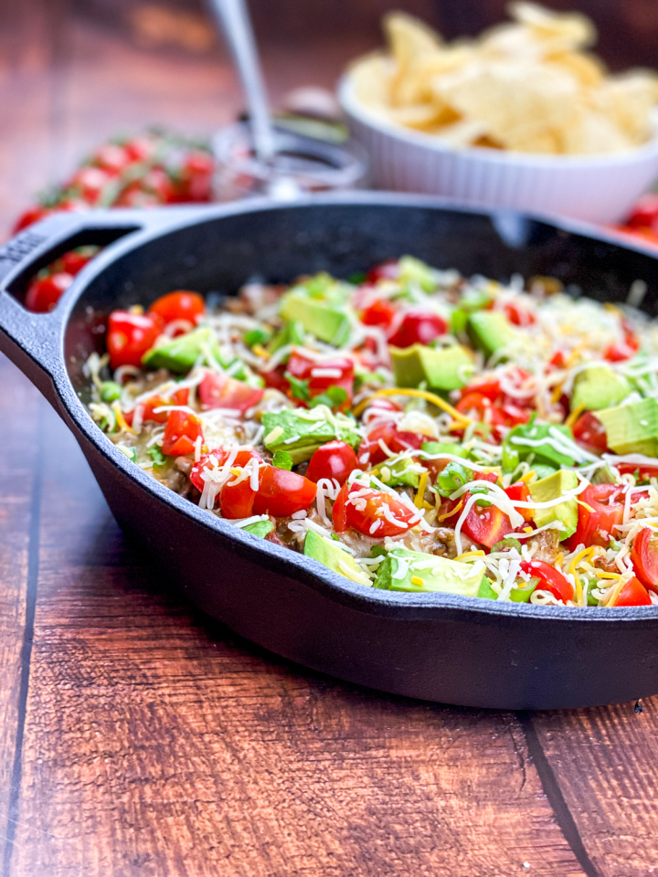 cast iron skillet with taco mixture and toppings