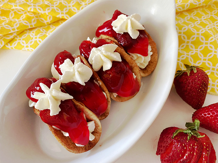 cheesecake cinnamon tacos topped with strawberry pie filling