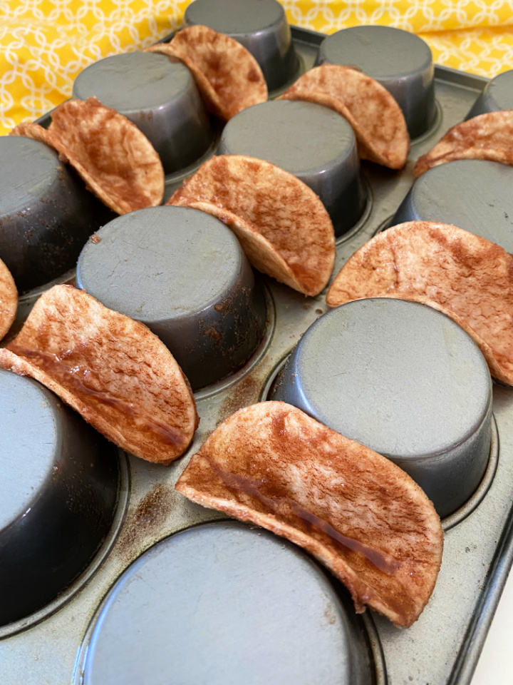 cinnamon sugar taco shells formed on a muffin pan