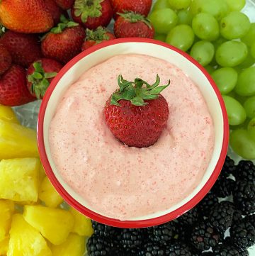 Serve this strawberry cream cheese fruit dip at your next gathering, party, or anytime. Picture is an overhead shot of fruit dip and fruit tray