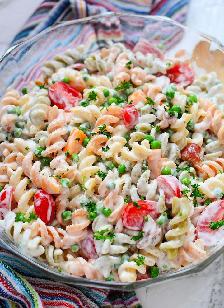 close up of bowl filled with bacon tomato pasta salad with ranch dressing
