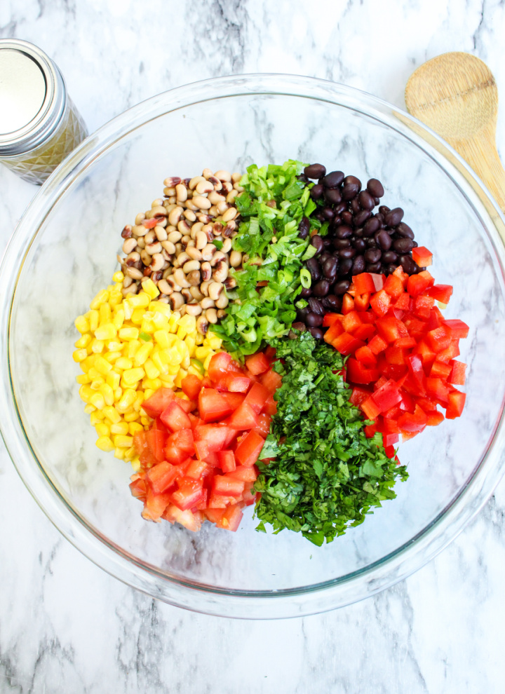glass bowl filled with fresh ingredients for Texas caviar dip
