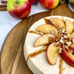 cheese cake with cinnamon and topped with apples and nuts.