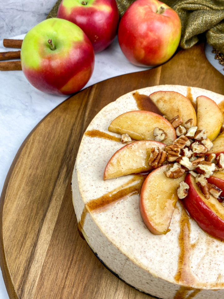 cheese cake with cinnamon and topped with apples and nuts.