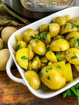buttered potatoes with parsley in white casserole dish and Instant Pot in background