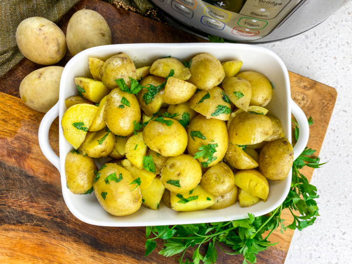 parsley potatoes in casserole dish that were cooked in the Instant Pot