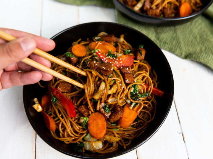 pork lo mein in bowl and chopsticks