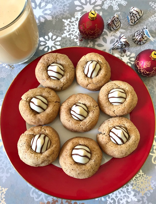 Eggnog Blossoms are a fun way to celebrate the holidays and all things cookies. I’ve added a white chocolate kiss to the top of each cookie, for an even more festive look and taste.  
