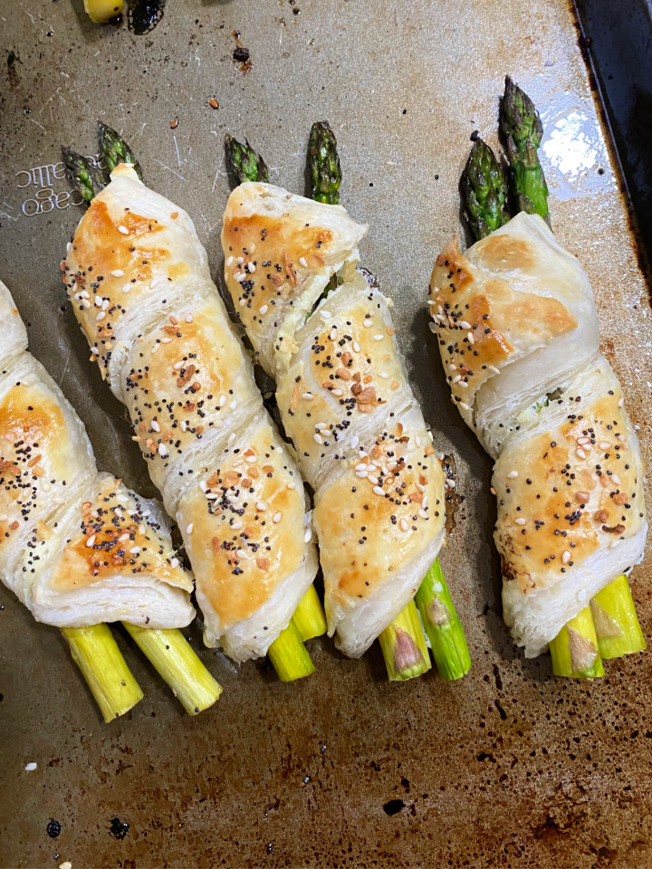 asparagus bundles in puff pastry on baking sheet cooling