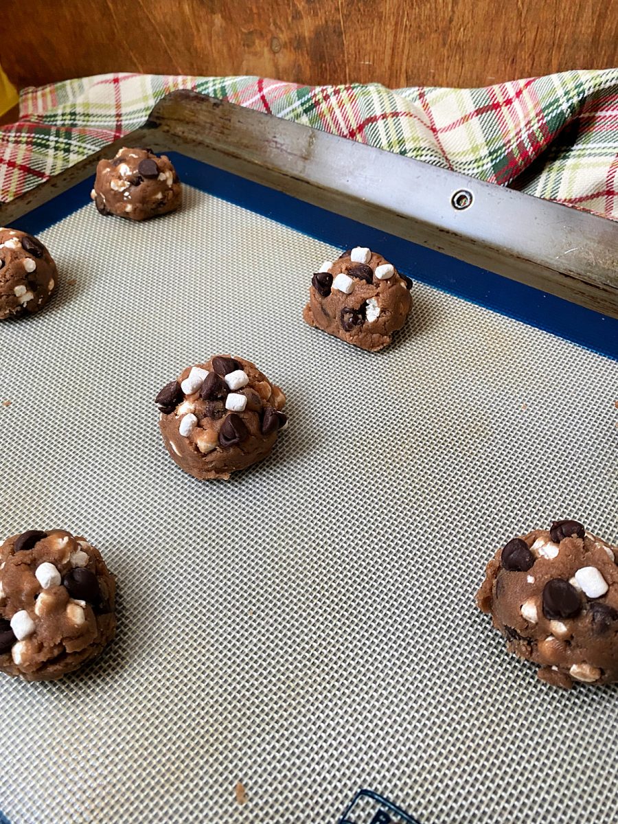 hot chocolate cookie dough balls on baking sheet
