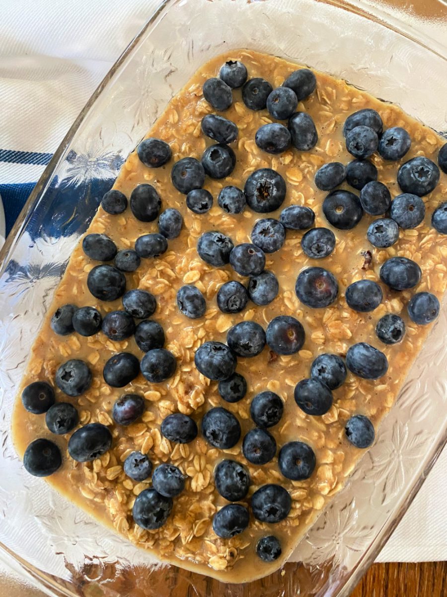 baking dish with layer of oatmeal and blueberries