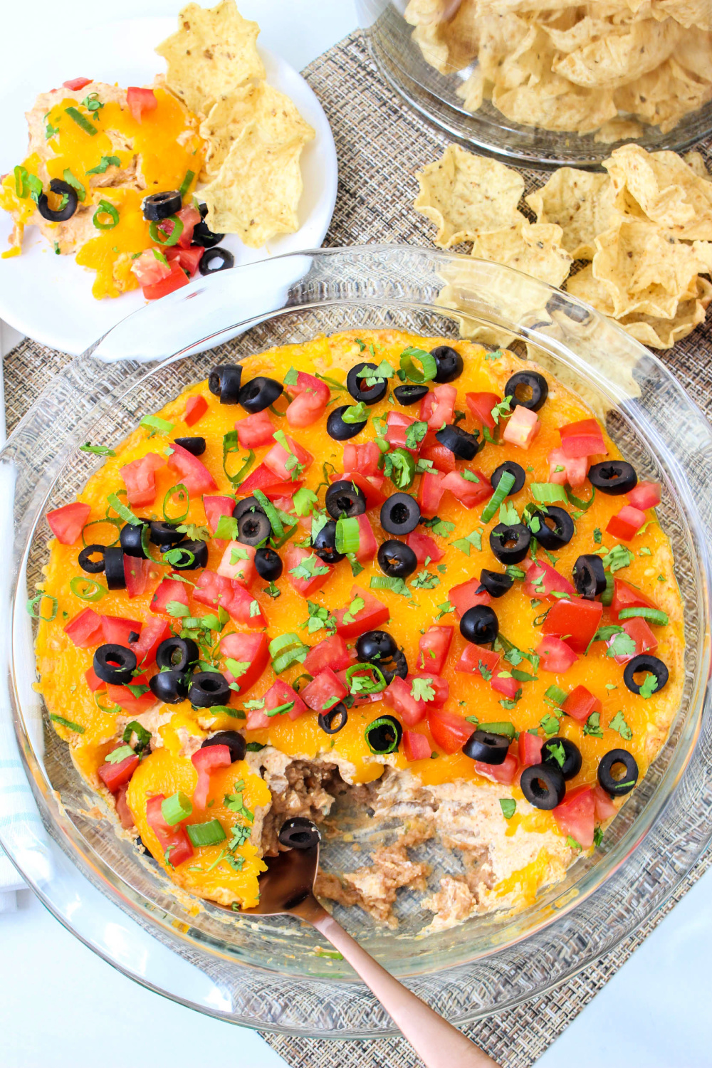 hot baked taco dip overhead view with plate of chips