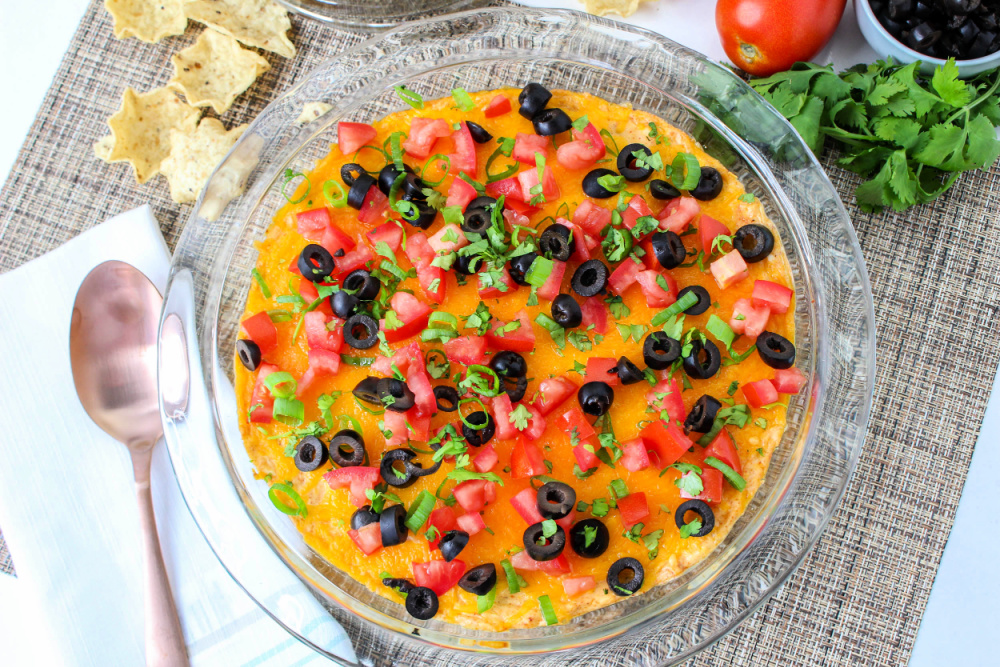 quick and easy taco dip in glass dish with chips in background